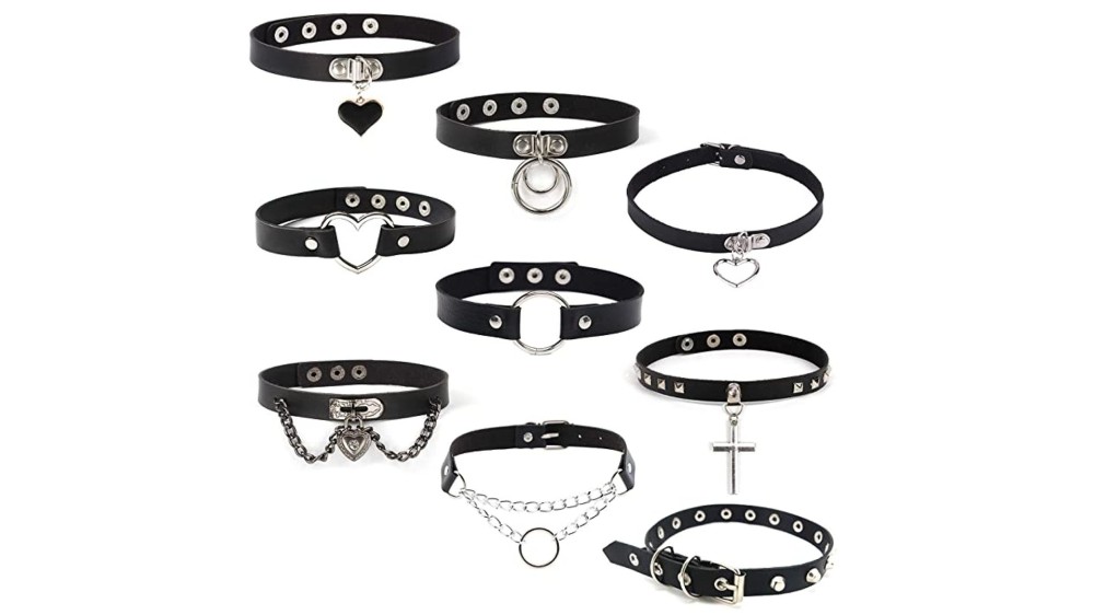 multiple goth style leather and metal chokers on white background 