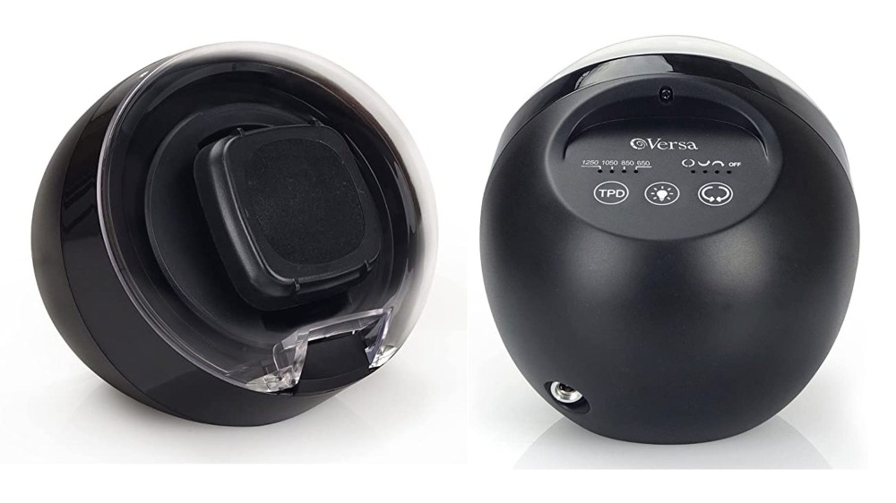 A front and back view of a small black watch winder that has a rounded shape.