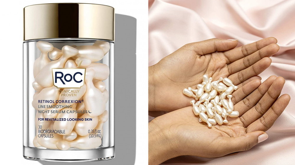 A person holds retinol capsules in her hand.