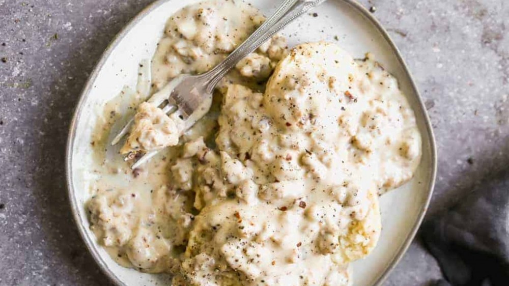 Biscuits and gravy on a plate.