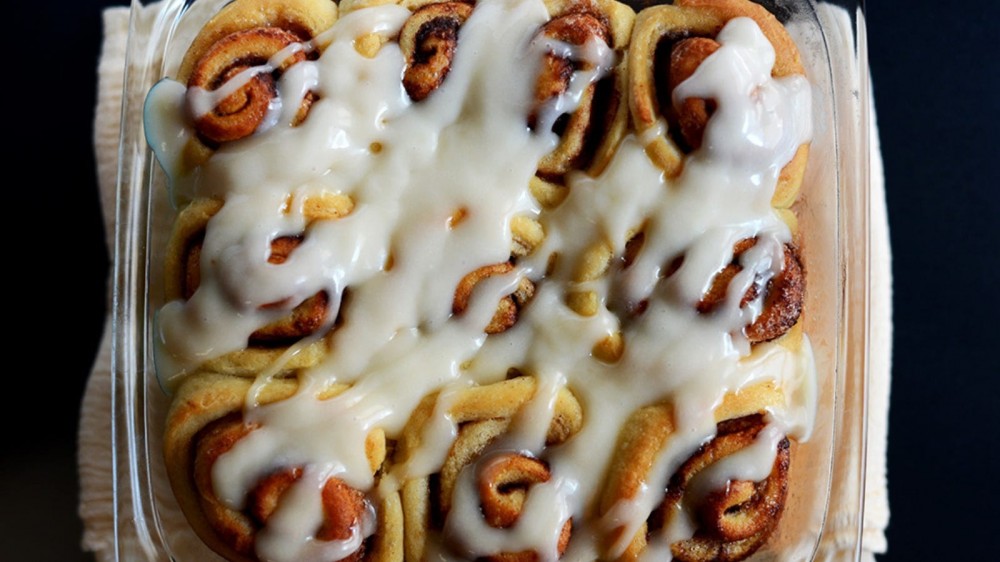 A casserole dish filled with warm and gooey cinnamon rolls.