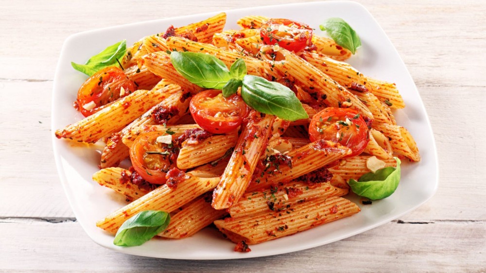 Spicy penne pasta dish with basil and tomatoes