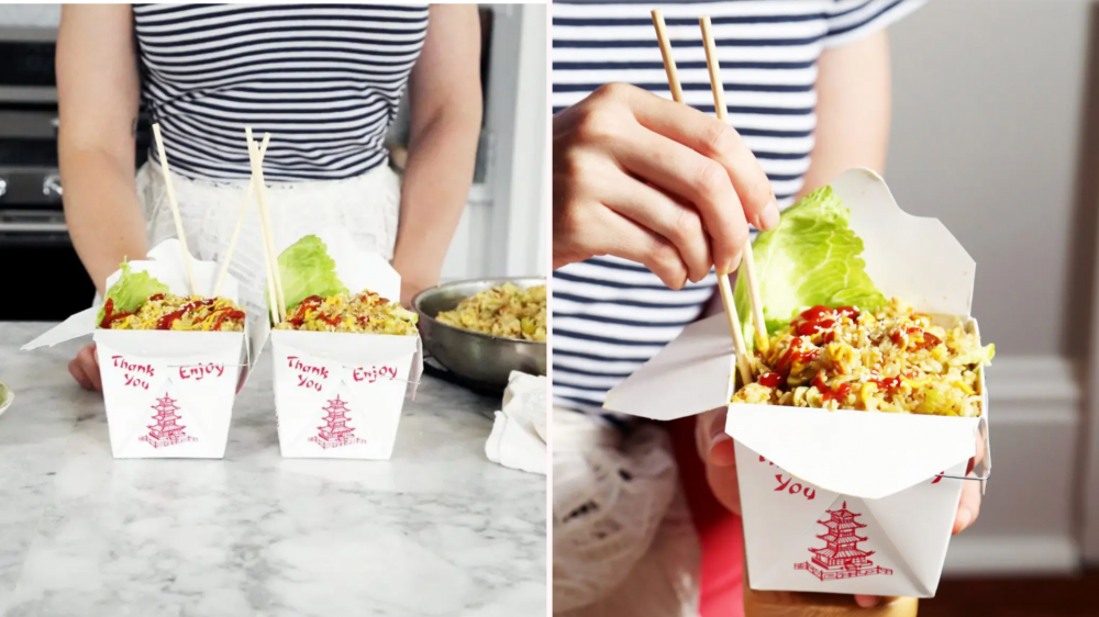 Woman using chopsticks to pick up cheeseburger fried rice in a takeout container